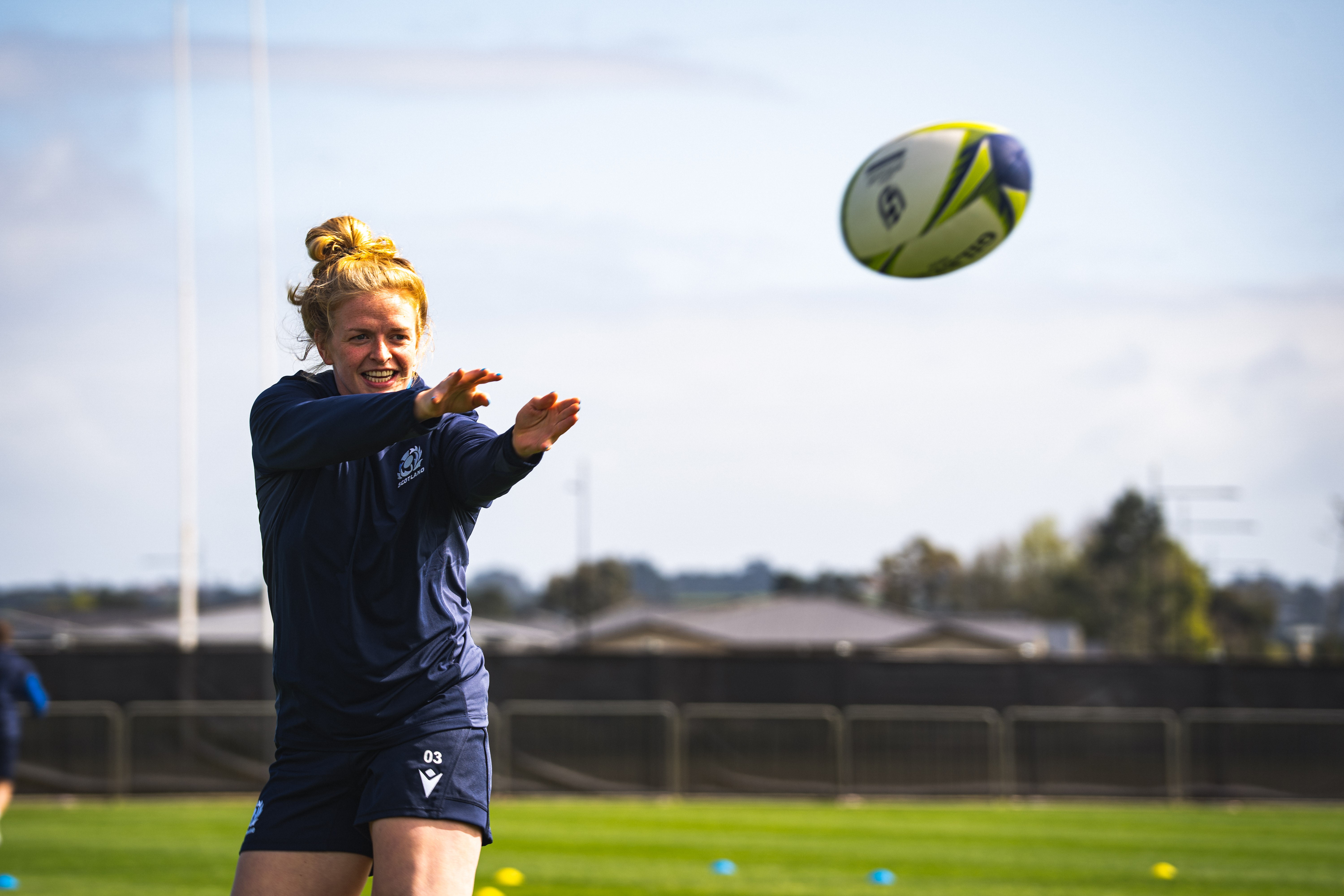 Image shows rugby player throwing ball.
